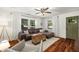 Bright living room is filled with natural light, featuring a large sectional and hardwood floors at 324 Pine Ne St, Marietta, GA 30060