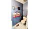 This bathroom features a toilet and sink with blue walls and decorations at 4256 Village Square Ln, Stone Mountain, GA 30083