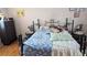 Cozy bedroom featuring a wrought iron bed frame and hardwood floors at 4256 Village Square Ln, Stone Mountain, GA 30083
