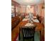 Inviting dining room features wood table, chairs, china cabinet, and charming chandelier at 4256 Village Square Ln, Stone Mountain, GA 30083