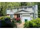 Charming two-story home with siding, brick accents, and an attached one-car garage at 4256 Village Square Ln, Stone Mountain, GA 30083