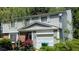 Charming two-story home with siding, brick accents, and an attached one-car garage at 4256 Village Square Ln, Stone Mountain, GA 30083