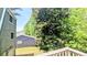 Exterior of home with trees and partial view of the neighboring home at 4256 Village Square Ln, Stone Mountain, GA 30083