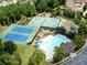 Aerial view showcasing tennis courts, basketball courts, a pool, a clubhouse, and a playground at 632 Eagles Nest Cir, Auburn, GA 30011