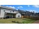Spacious backyard featuring green grass and a wooden fence for privacy at 632 Eagles Nest Cir, Auburn, GA 30011