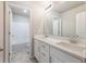 Bathroom featuring dual sinks, a large mirror, white cabinetry, and a tub/shower combo at 632 Eagles Nest Cir, Auburn, GA 30011