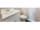 Bathroom vanity featuring double sinks, white countertop and cabinets paired with a coordinating toilet at 632 Eagles Nest Cir, Auburn, GA 30011