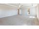 Spacious bedroom with a tray ceiling, neutral carpet, and ample natural light at 632 Eagles Nest Cir, Auburn, GA 30011