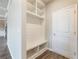 Entryway area with custom built-in shelves and bench space adjacent to a door, all in bright white at 632 Eagles Nest Cir, Auburn, GA 30011