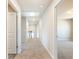 A bright hallway with plush carpet, white walls and doors, and recessed lighting at 632 Eagles Nest Cir, Auburn, GA 30011