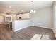 A kitchen featuring white cabinets, an island, and modern lighting fixtures that illuminates the space at 632 Eagles Nest Cir, Auburn, GA 30011