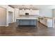 Modern kitchen features white cabinets, a gray island, stainless steel appliances, and pendant lighting at 632 Eagles Nest Cir, Auburn, GA 30011