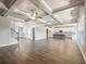 Expansive living room with hardwood floors, coffered ceilings, open layout, and access to kitchen at 632 Eagles Nest Cir, Auburn, GA 30011