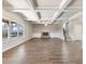 Bright living room featuring coffered ceilings, a brick fireplace, built-in shelving, and hardwood floors at 632 Eagles Nest Cir, Auburn, GA 30011