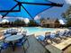 Community swimming pool with tables, umbrellas, lounge chairs, and a pool house at 632 Eagles Nest Cir, Auburn, GA 30011