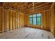 Bedroom during construction featuring wood framing and large window overlooking green space at 120 Wood River Ct, Johns Creek, GA 30097