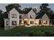 Elegant two-story home with a brick and stone facade, manicured lawn, and professional landscaping at 120 Wood River Ct, Johns Creek, GA 30097
