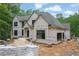 Two-story home under construction featuring windows and a partially completed facade at 120 Wood River Ct, Johns Creek, GA 30097