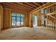 Open-concept space with grand windows, highlighting the modern unfinished staircase and archway at 120 Wood River Ct, Johns Creek, GA 30097