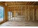 Interior view of a home under construction, showing wood framing, windows, and electrical wiring at 120 Wood River Ct, Johns Creek, GA 30097