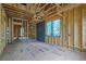 Interior view of a home under construction with wood framing, window elements, and utility features at 120 Wood River Ct, Johns Creek, GA 30097