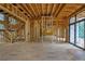 Spacious, unfinished living room featuring a staircase and a fireplace, flooded with natural light at 120 Wood River Ct, Johns Creek, GA 30097