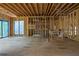 Unfinished living room with exposed framing, wiring, and a large window at 120 Wood River Ct, Johns Creek, GA 30097