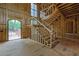 A staircase is the focal point with a large window and an arched entryway to the side at 120 Wood River Ct, Johns Creek, GA 30097