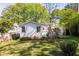 Landscaped backyard with a white house, wooden fence, and lush greenery, perfect for outdoor enjoyment at 1421 Smith Se St, Atlanta, GA 30316