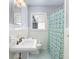 This bathroom includes a window, sink and a tiled shower and walls at 1421 Smith Se St, Atlanta, GA 30316