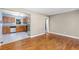 Open kitchen featuring stainless steel appliances, wooden cabinetry, tile floor, and breakfast bar at 1421 Smith Se St, Atlanta, GA 30316