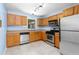 This kitchen features wooden cabinets, stainless steel appliances and tile floors at 1421 Smith Se St, Atlanta, GA 30316