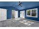 Spacious bedroom with vaulted ceiling, ceiling fan, carpeted floor, and access to the backyard at 1421 Smith Se St, Atlanta, GA 30316