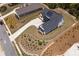 An aerial view showcases a modern home's dark roof, lengthy driveway, and landscaped front yard in a community at 247 Terrace View Dr, Acworth, GA 30101