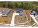 Modern farmhouse-style home with meticulously landscaped yard, lengthy drive, and wooded backdrop on a sunny day at 247 Terrace View Dr, Acworth, GA 30101