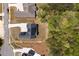 Aerial view of a modern home surrounded by a well-manicured lawn, landscaping, and a private tree line at 247 Terrace View Dr, Acworth, GA 30101