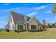 Large backyard featuring a brick foundation, patio, and plentiful grass, providing ample space for activities at 247 Terrace View Dr, Acworth, GA 30101
