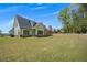 A sprawling backyard featuring plenty of green grass and mature trees that create a serene, park-like setting at 247 Terrace View Dr, Acworth, GA 30101