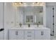 Sleek bathroom featuring double sinks with white marble countertops and gold fixtures at 247 Terrace View Dr, Acworth, GA 30101
