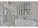 Stylish bathroom features a soaking tub, a walk-in shower, and bright natural light at 247 Terrace View Dr, Acworth, GA 30101