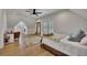 Finished attic bedroom with ceiling fan, hardwood floors, natural light, bed, and office setup at 247 Terrace View Dr, Acworth, GA 30101