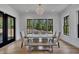 Elegant dining room with a rustic table and large windows showcasing a scenic view at 247 Terrace View Dr, Acworth, GA 30101