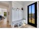 Inviting entryway with custom mudroom bench and coat rack, with a view into a piano room and outdoor scenery at 247 Terrace View Dr, Acworth, GA 30101