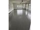 Spacious garage featuring a durable epoxy floor and natural light through multiple windows, perfect for car enthusiasts at 247 Terrace View Dr, Acworth, GA 30101