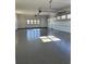 A large garage with sealed concrete floors and windows above the two garage doors, offering ample lighting at 247 Terrace View Dr, Acworth, GA 30101