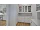 Bright kitchen featuring custom white cabinets with glass fronts and gold hardware accents at 247 Terrace View Dr, Acworth, GA 30101