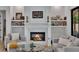 Comfortable living room featuring a cozy fireplace, stylish decor, and built-in shelving at 247 Terrace View Dr, Acworth, GA 30101