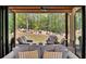 Relaxing outdoor living space featuring comfortable seating and a picturesque view of the trees and stone accents at 247 Terrace View Dr, Acworth, GA 30101