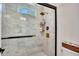Modern shower with glass doors, marble-tiled walls, bronze fixtures and a rain shower head at 247 Terrace View Dr, Acworth, GA 30101