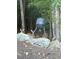 A group of deer gather near a feeding station amongst trees and rocks in the property's wooded area at 247 Terrace View Dr, Acworth, GA 30101